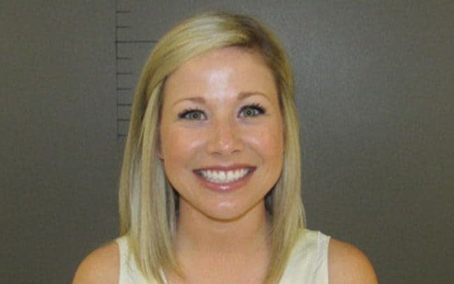 Sarah Fowlkes grinned into the camera after being arrested on suspicion of having sex with a student. - Lockhart Police Department