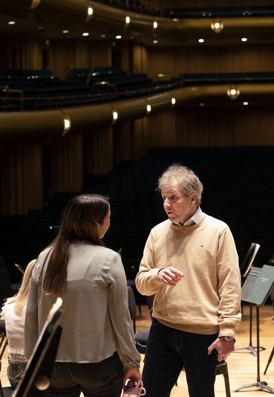 Thierry Fischer, music director of the Utah Symphony, visits with principal horn player Jessica Danz before rehearsal at Abravanel Hall in Salt Lake City on Thursday, May 25, 2023. Fischer concludes his 14 years with the symphony this weekend. | Laura Seitz, Deseret News