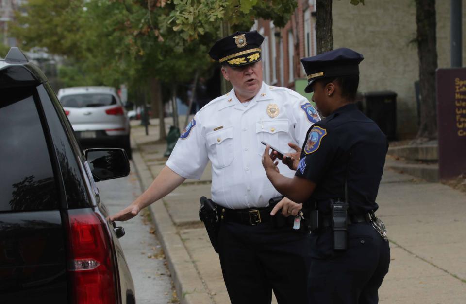 Wilmington Police Chief Robert Tracy speaks with a fellow officer after visiting the site of a second shooting of the day in 2019.