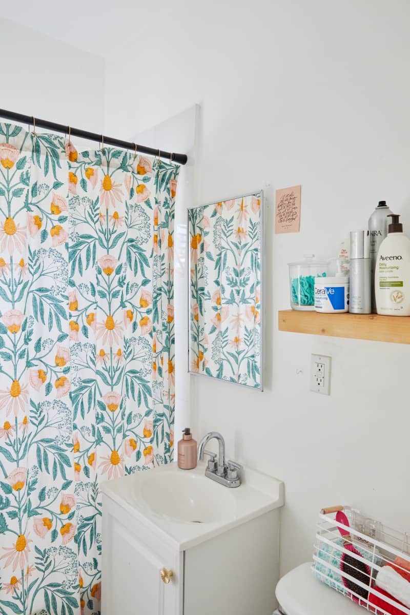Bathroom with floral shower curtain.