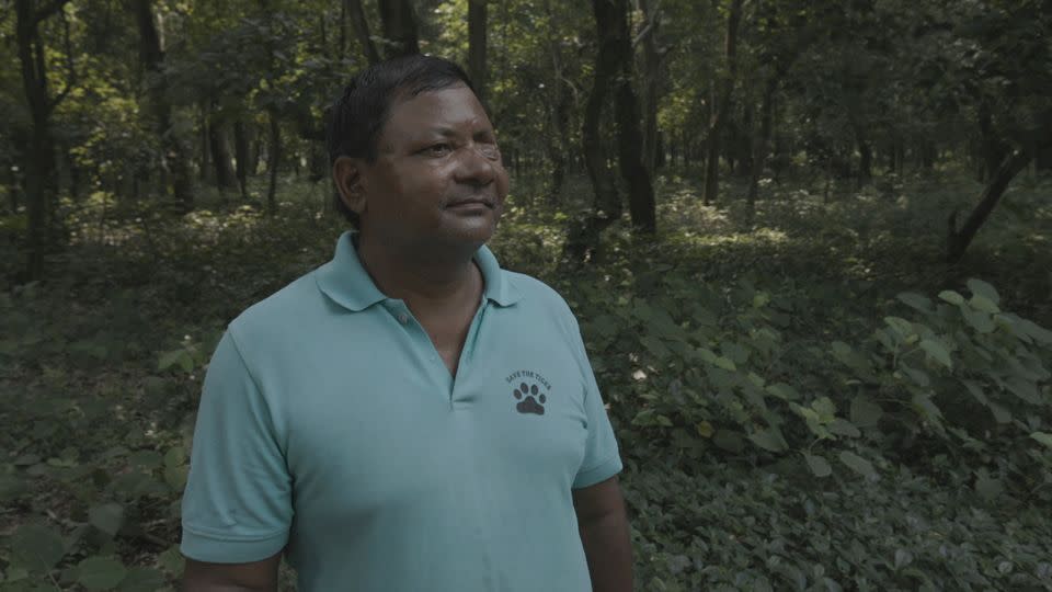 Bhadai Tharu, pictured, was attacked by a tiger and lost his eye in 2004. He works in tiger conservation, reducing human-animal conflict. - Vijay Bedi/CNN