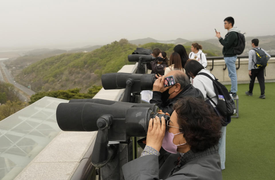 Visitors watch the North Korea side from the Unification Observation Post in Paju, South Korea, near the border with North Korea, Thursday, April 13, 2023. North Korea on Thursday conducted its first intercontinental ballistic missile launch in a month, possibly testing a new type of more mobile, harder-to-detect weapons system, its neighbors said, in an extension of the North's provocative run of missile tests. (AP Photo/Ahn Young-joon)