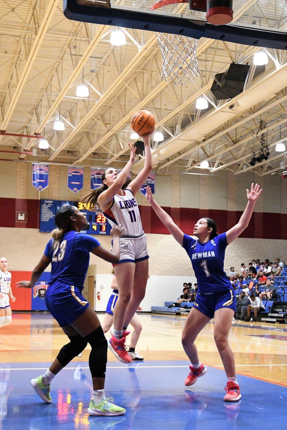 King's Academy's Sophia Kateris extends for a layup attempt during the first half of the Lions' district championship win over Cardinal Newman on Feb. 3 2023.