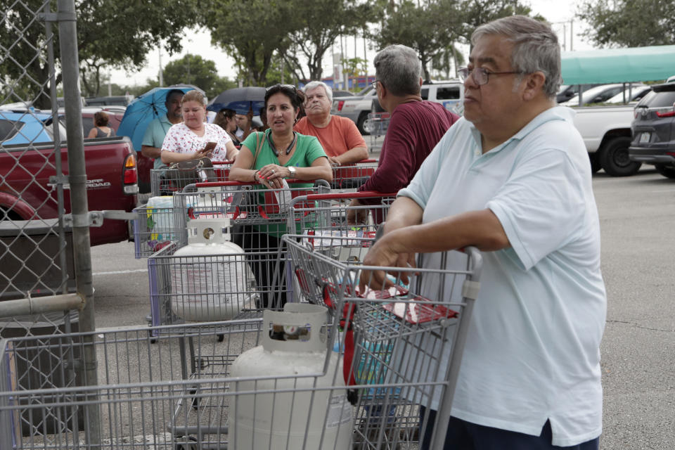 People stand in line for propane fuel at BJ's Wholesale Club in preparation for Hurricane Dorian, Thursday, Aug. 29, 2019, in Hialeah, Fla. Hurricane Dorian is heading towards Florida for a possible direct hit on the state over Labor Day. (AP Photo/Lynne Sladky)