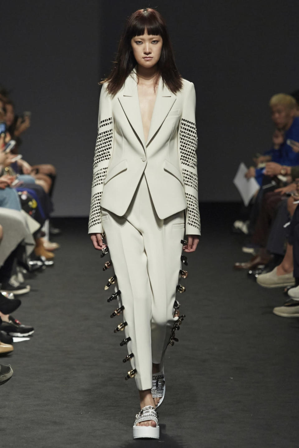 Superfluous safety pins lined pretty trousers at Seoul Fashion Week. 