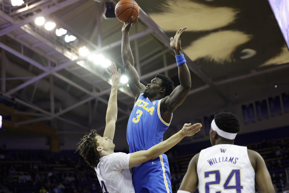 UCLA forward Adem Bona shoots over Washington center Braxton Meah, left during the first half of an NCAA college basketball game, Sunday, Jan. 1, 2023, in Seattle. (AP Photo/John Froschauer)