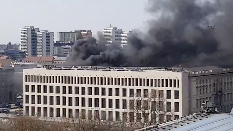 Smoke rises over the Berlin Palace (Stadtschloss) in Berlin