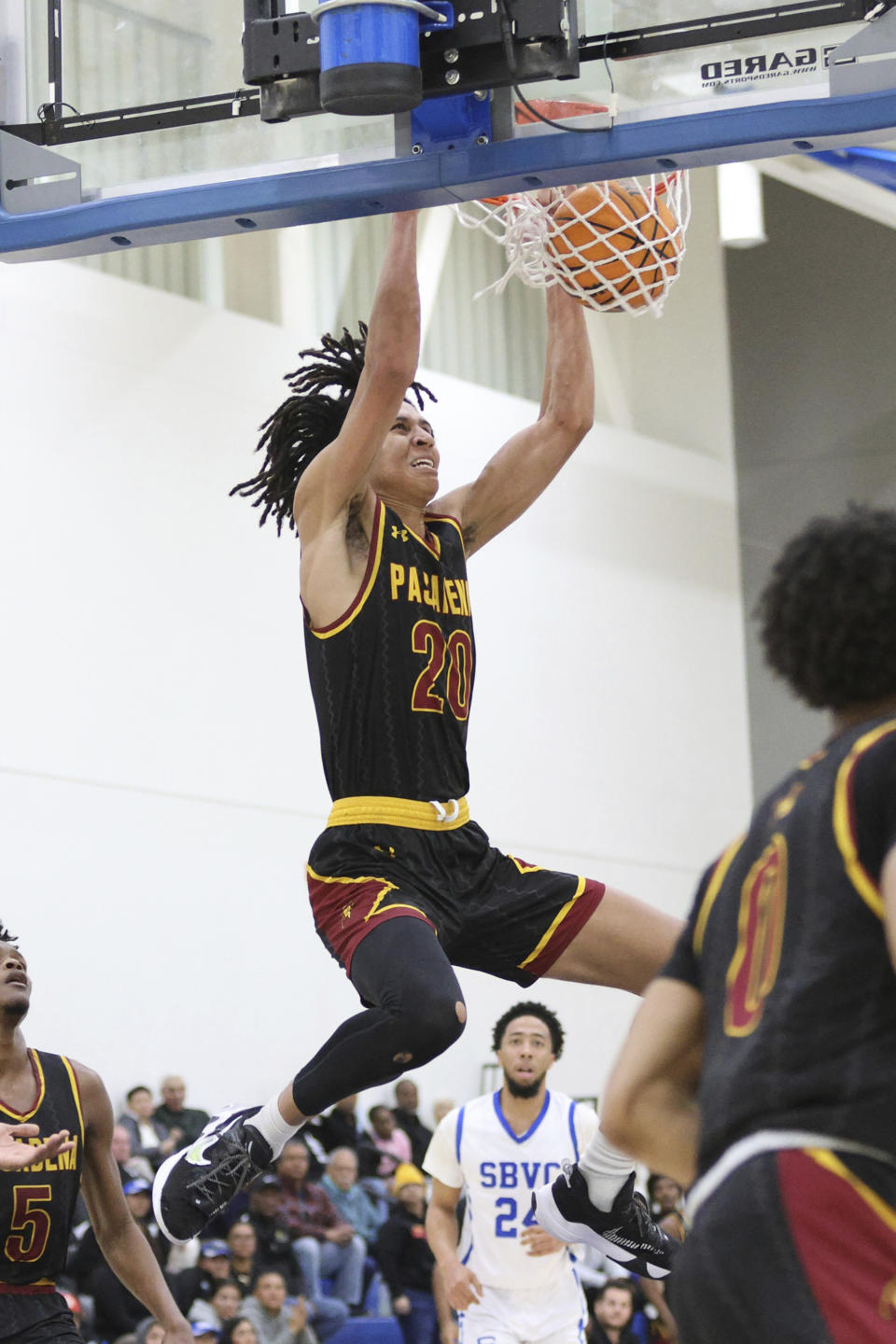 In this photo provided by Pasadena City College, Pasadena City College NCAA college basketball player Nigel Wilson dunks against San Bernardino Community College in San Bernardino, Calif., March 4, 2023. Nigel Wilson and twin sisters Anysa and Amaya Gray have been recognized for overcoming adversity to succeed on and off the field. Wilson, a basketball player for Pasadena City College, and the Gray twins, who play soccer for California, are this year's recipients of the CalHope Courage Award. They received their awards on Tuesday, May 9, 2023. (Richard Quinton/Pasadena City College via AP)