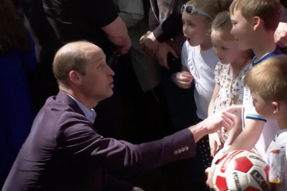 Prince William greeting royal fans who have arrived at Windsor Castle hours before the coronation concert is set to begin at 8pm (Reuters)