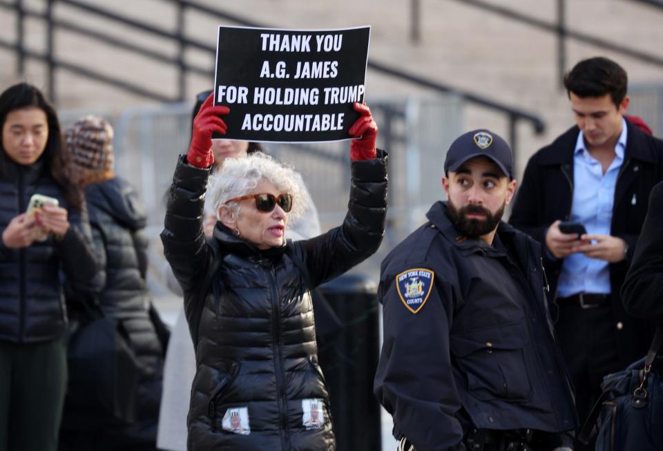 A protestor holds a sign as Ivanka Trump, former President Donald Trump's daughter, enters New York State Supreme Court for his civil fraud trial on Nov. 8, 2023 in New York City. Former President Trump has testified in the case that alleges he and his two sons Donald Trump Jr. and Eric Trump conspired to inflate his net worth on financial statements provided to banks and insurers to secure loans. New York Attorney General Letitia James has sued seeking $250 million in damages. Ivanka Trump is scheduled to testify today after her lawyers were unable to block her testimony.