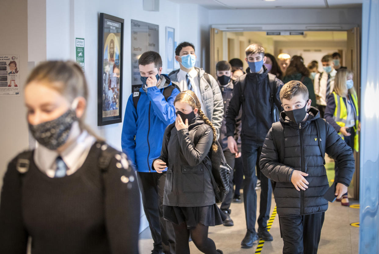 Students at St Columba's High School, Gourock, Scotland, wear protective face masks as the requirement for secondary school pupils when moving around school comes into effect from today across Scotland, Monday Aug. 31, 2020. (Jane Barlow/PA via AP)