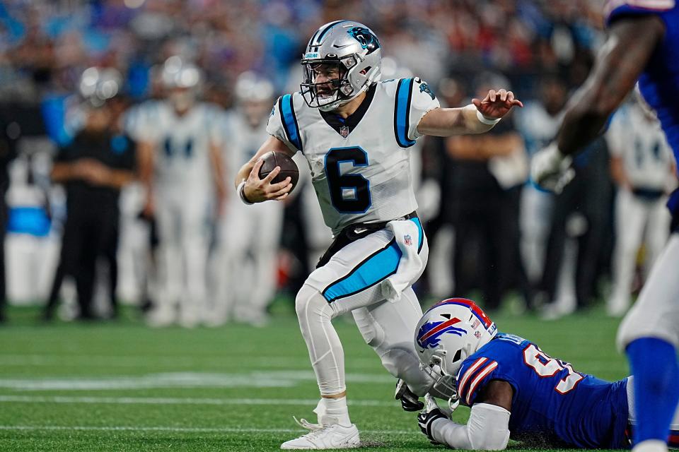 Carolina Panthers quarterback Baker Mayfield is tackled by Buffalo Bills defensive end Shaq Lawson during the first half of an NFL preseason football game on Friday, Aug. 26, 2022, in San Diego. (AP Photo/Rusty Jones)