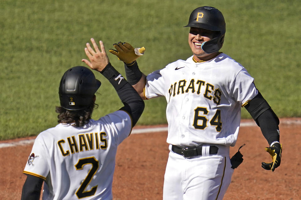 Pittsburgh Pirates' Diego Castillo (64) is greeted by teammate Michael Chavis as he crosses home plate after hitting a three-run home run off San Francisco Giants starting pitcher Alex Wood during the third inning of a baseball game in Pittsburgh, Saturday, June 18, 2022. (AP Photo/Gene J. Puskar)