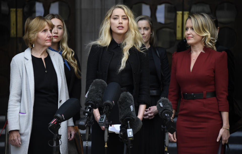 American actress Amber Heard, former wife of actor Johnny Depp, center, gives a statement after the end of the trial outside the High Court in London, Tuesday, July 28, 2020. Hollywood actor Johnny Depp is suing News Group Newspapers over a story about his former wife Amber Heard, published in The Sun in 2018 which branded him a 'wife beater', a claim he denies. (AP Photo/Alberto Pezzali)