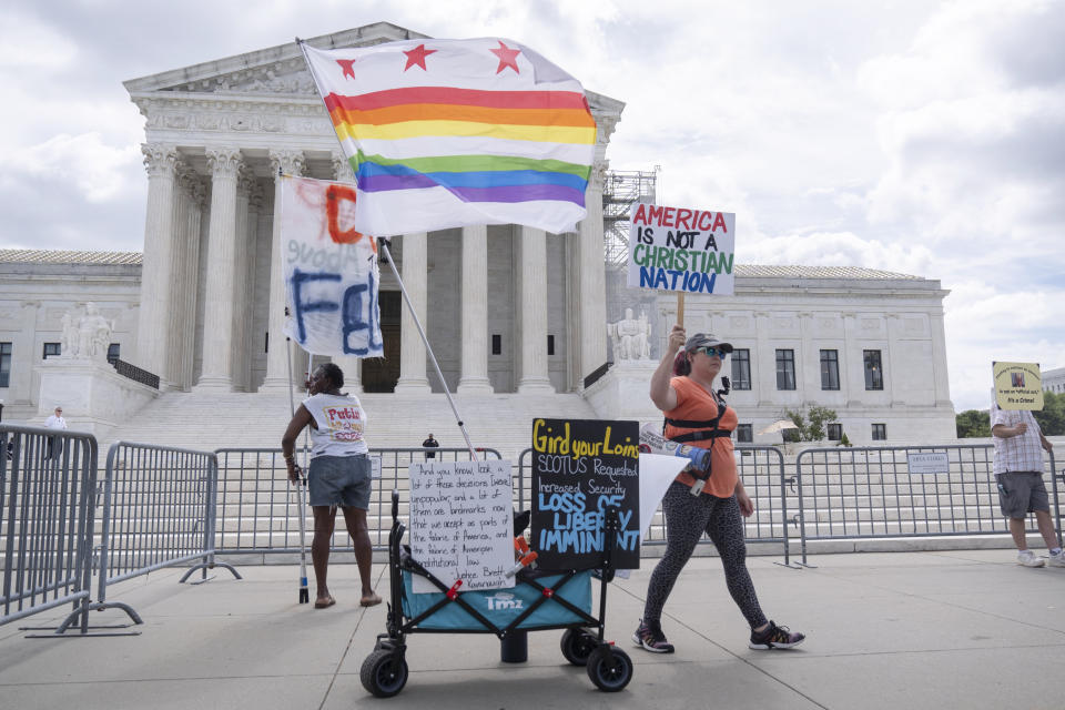 Demonstrators stand outside the Supreme Court on Thursday, June 27, 2024, in Washington. The Supreme Court cleared the way Thursday for Idaho hospitals to provide emergency abortions for now in a procedural ruling that left key questions unanswered and could mean the issue ends up before the conservative-majority court again soon. (AP Photo/Mark Schiefelbein)