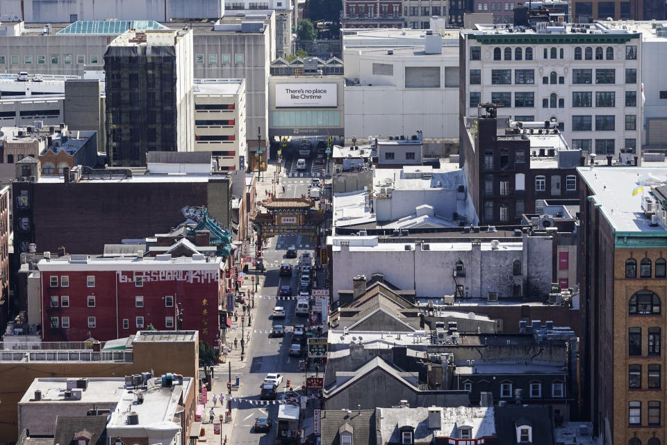 Shown in the top right is the Fashion District shopping center and the proposed location of a new Philadelphia 76ers NBA basketball arena, while in the foreground, the Chinatown neighborhood of Philadelphia is seen, Friday, July 22, 2022. (AP Photo/Matt Rourke)