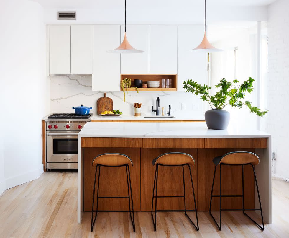 a kitchen with a stove and stools