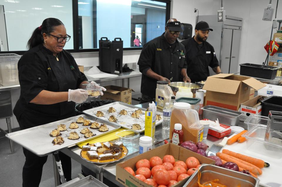 Preparing meals Jan. 12 for the café at the new Food Bank of Delaware facility in Milford are, from left, chef Shalisa Alexander, executive chef Tim Hunter and café coordinator J.R. Duffy.