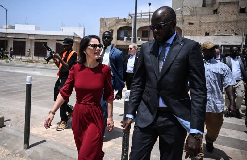 Annalena Baerbock, Germany's Foreign Minister, talks to the Senegalese Minister for Infrastructure, Malick Ndiaye (R). The trip focuses on efforts to stabilize the Sahel region. Britta Pedersen/dpa