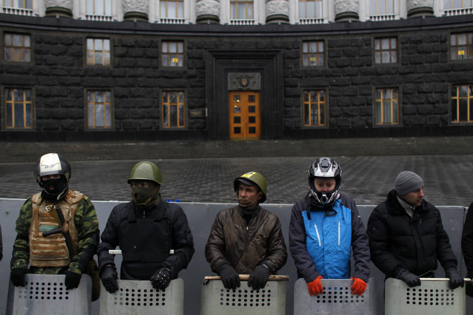 Protesters guard the Ukrainian government building in Kiev, Ukraine, Sunday, Feb. 23, 2014. The Kiev protest camp at the center of the anti-President Viktor Yanukovych movement filled with more and more dedicated demonstrators Sunday morning setting up new tents after a day that saw a stunning reversal of fortune in a political standoff that has left scores dead and worried the United States, Europe and Russia. (AP Photo/ Marko Drobnjakovic)