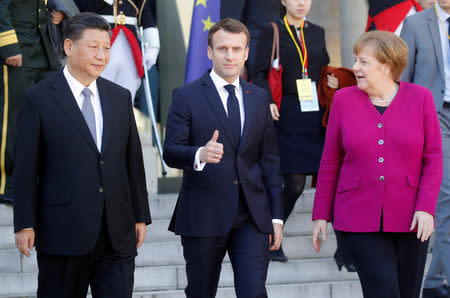 French President Emmanuel Macron, German Chancellor Angela Merkel and Chinese President Xi Jinping leave following a meeting at the Elysee Palace in Paris, France, March 26, 2019. REUTERS/Philippe Wojazer