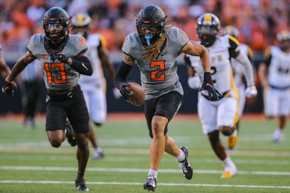 Sep 17, 2022; Stillwater, Oklahoma, USA; Oklahoma State's Korie Black (2) picks up a blocked kick and returns it for a touchdown in the first half during a football game between Oklahoma State Cowboys and Arkansa at Pine Bluff Golden Lions at Boone Pickens Stadium. Mandatory Credit: Nathan J. Fish-USA TODAY Sports