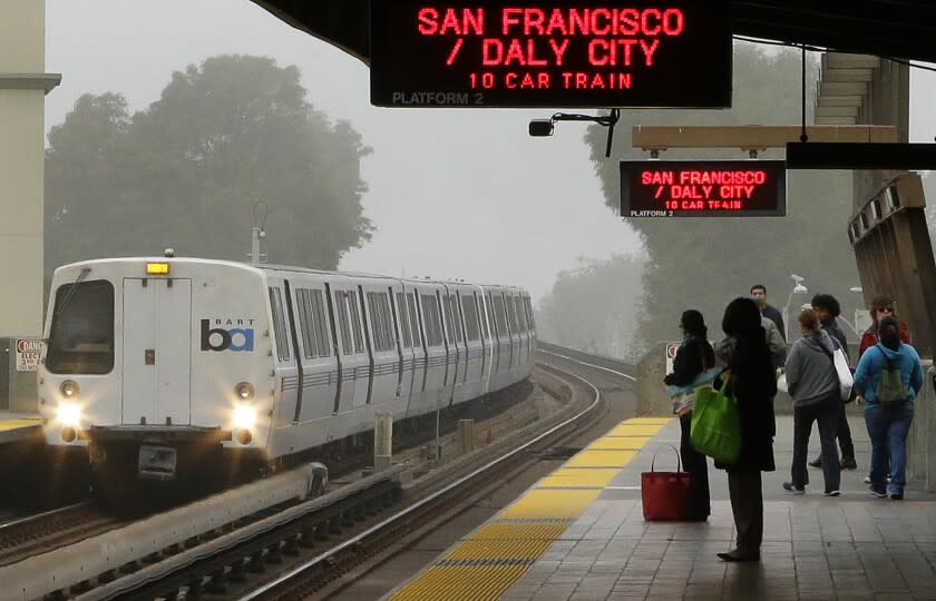 FILE - Bay Area Rapid Transit passengers wait for a train in this Oct. 22, 2013 file photo taken in Oakland, Calif. San Francisco Bay Area Rapid Transit&#39;s contract with its two largest unions appears to be facing uncertainty late Friday Nov. 15, 2013 as the agency called for a return to the bargaining table, just weeks after the agreement settled a dispute that has already caused two strikes. (AP Photo/Ben Margot, File)