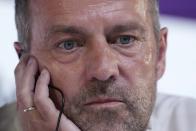 Germany's head coach Hansi Flick listens to questions during a news conference on the eve of the group E World Cup soccer match between Germany and Costa Rica, in Doha, Qatar, Wednesday, Nov. 30, 2022. Germany will play the third match against Costa Rica on Thursday, Dec. 1. (AP Photo/Matthias Schrader)