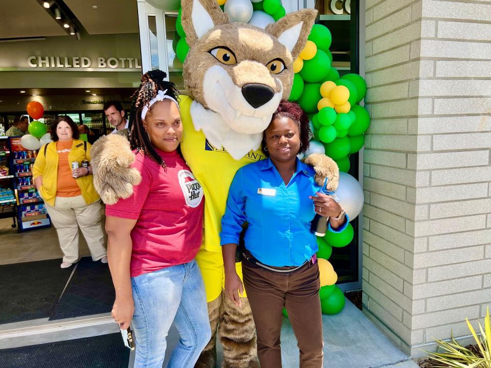 From left, Peaches Jackson and MAPCO District Manager Brandi Murff pose with Tempo the Coyote of Nashville Soccer Club at the new MAPCO at 2301 Carmack Blvd.