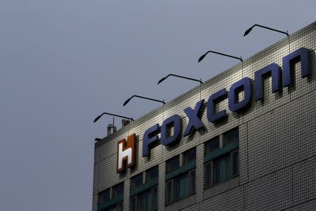 FILE PHOTO - The logo of Foxconn, the trading name of Hon Hai Precision Industry, is seen on top of the company's headquarters in New Taipei City, Taiwan on March 29, 2016. REUTERS/Tyrone Siu/File Photo