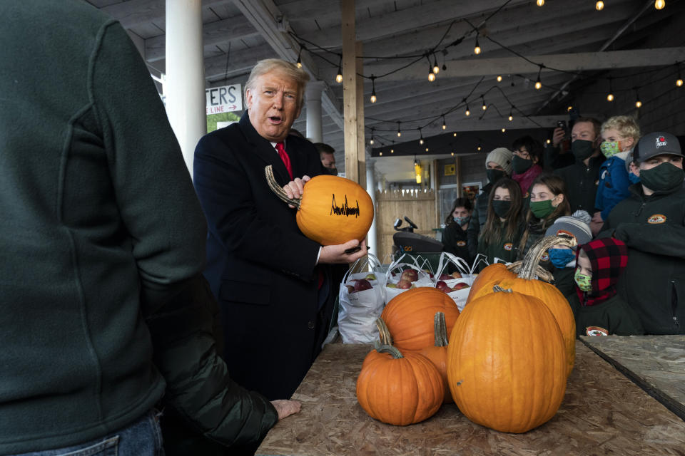 President Donald Trump signed a pumpkin during a visit to an orchard in Maine on Sunday. (Photo: ASSOCIATED PRESS)