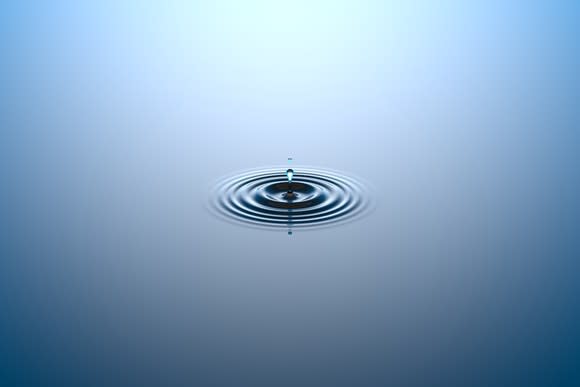 Water dropping onto a water surface.