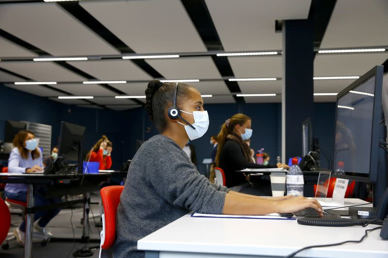 Employees work at the center for contact tracing of the Canton of Zurich in Pfaeffikon