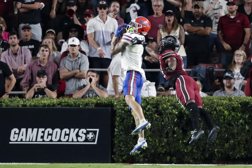 FILE - Florida wide receiver Ricky Pearsall (1) catches 21-yard game winning touchdown over South Carolina defensive back Nick Emmanwori (21) during the second half of an NCAA college football game on Saturday, Oct. 14, 2023, in Columbia, S.C. The former Florida standout is one of nearly a dozen receivers expected to be selected in the first two rounds of the draft beginning Thursday night. (AP Photo/Artie Walker Jr., File)