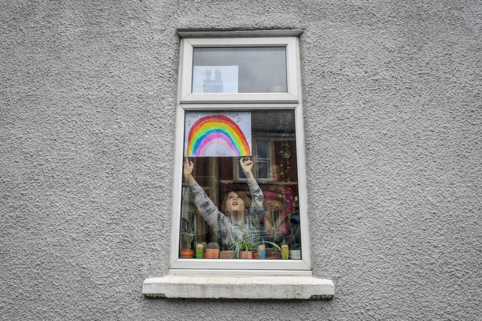 Jack Tucker, 7, places his rainbow in the window of a house in Bedminster, Bristol as the UK continues in lockdown to help curb the spread of the coronavirus.