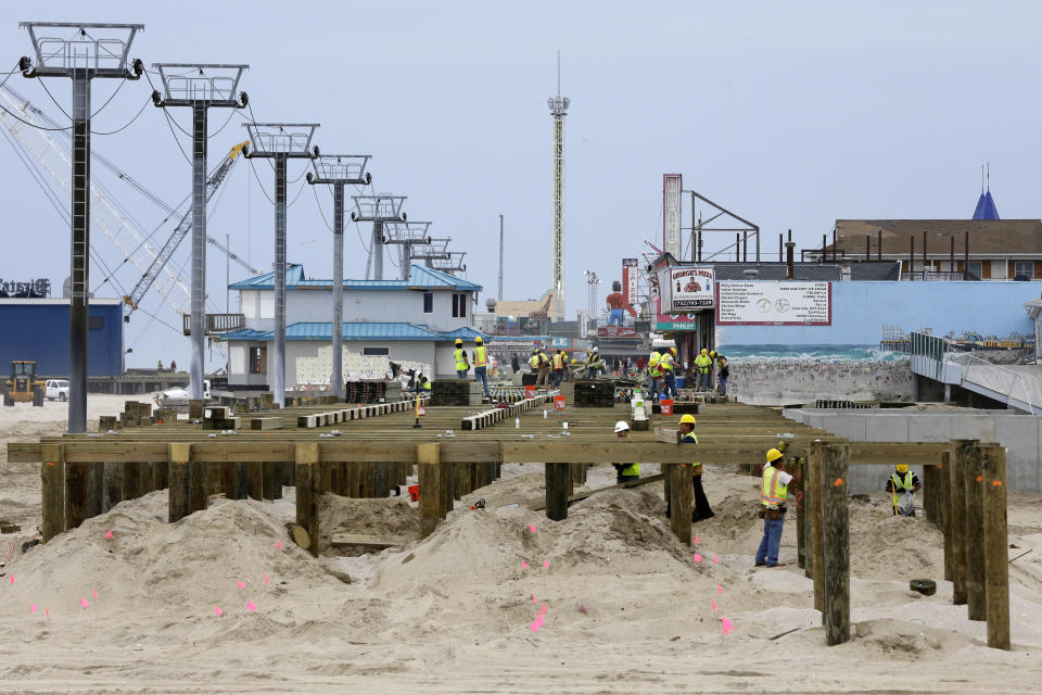 Construction of a new boardwalk continues on the northern end of Seaside Heights, N.J., Saturday, May 18, 2013. Visitors to the Jersey shore this weekend will find many of their favorite beaches and boardwalks ready for summer, thanks to a massive rebuilding effort after Superstorm Sandy. While several neighborhoods remain damaged, all but one of the storm-wrecked boardwalks should be ready for Memorial Day weekend, and amusement rides will still be available from Keansburg to Wildwood. Most beaches will be open, despite losing sand during the storm. (AP Photo/Mel Evans)