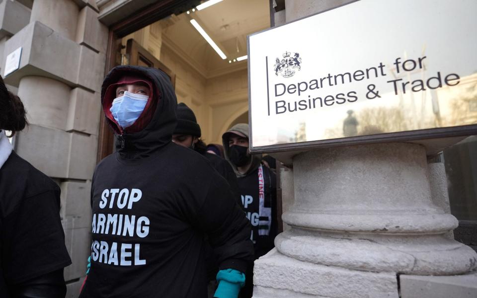 Pro-Palestine protesters leave the Department of Business and Trade