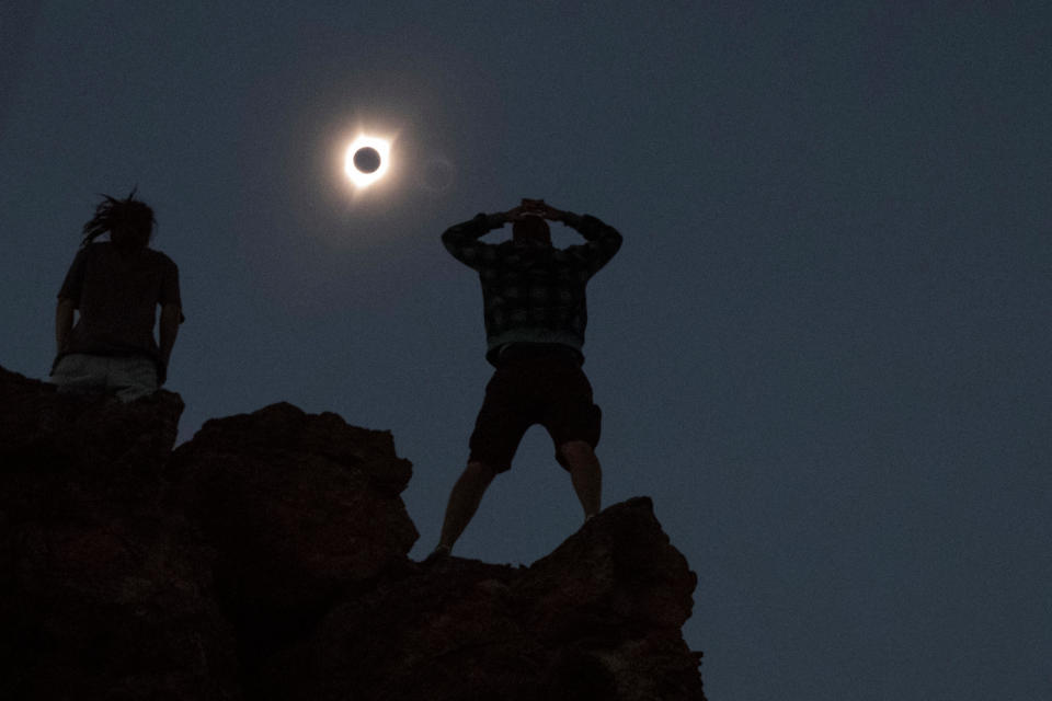 Tanner Person, right, and Josh Blink, both from Vacaville, California, watch a total solar eclipse at the John Day Fossil Beds National Monument, near Mitchell, Oregon, on Mon., Aug. 21, 2017. / Credit: Reuters