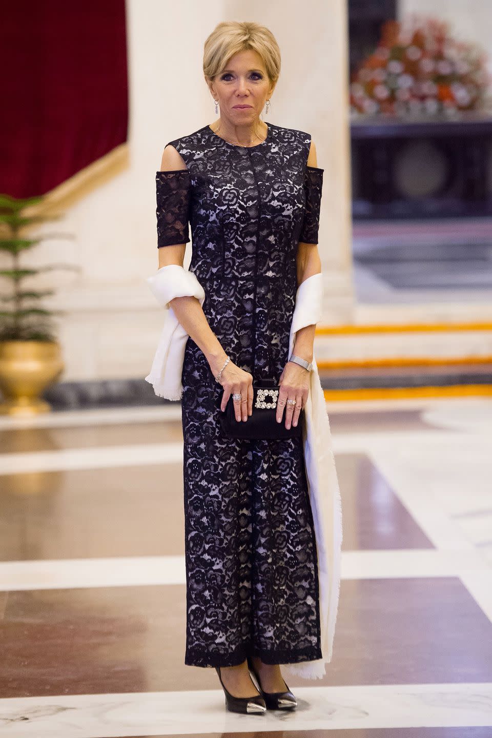 <p>Wearing a navy lace Louis Vuitton column dress and Roger Viver clutch for a dinner at the presidential palace in New Delhi, India</p>