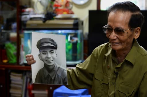 Vietnamese Dien Bien Phu veteran Nguyen Tran Viet, 87, shows a portrait of when he was a soldier