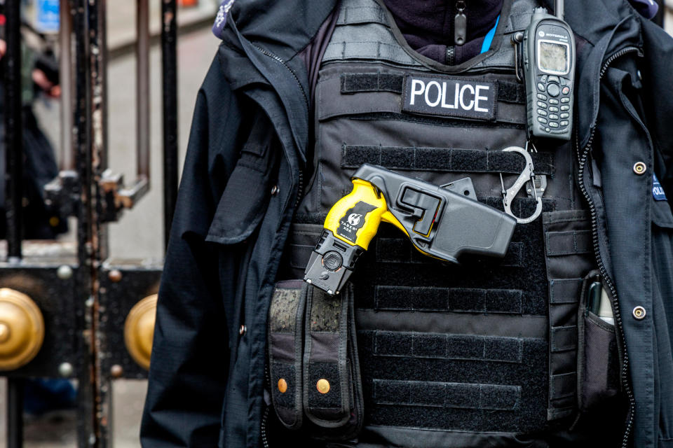 British Police Officer With Taser Gun, London, England