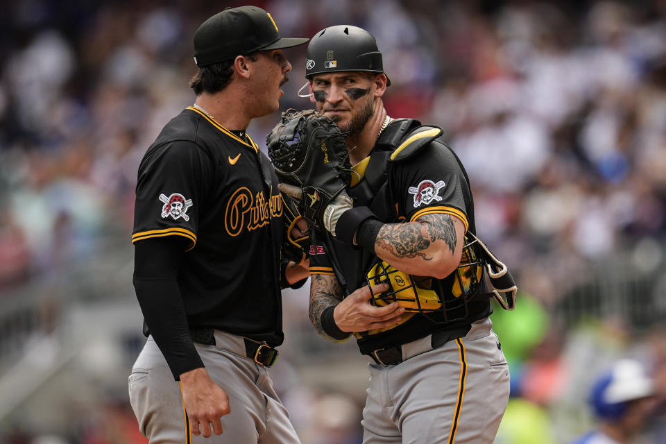 Pittsburgh Pirates catcher Yasmani Grandal (6) speaks with pitcher Paul Skenes (30) in the third inning of a baseball game against the Atlanta Braves, Saturday, June 29, 2024, in Atlanta. (AP Photo/Mike Stewart)