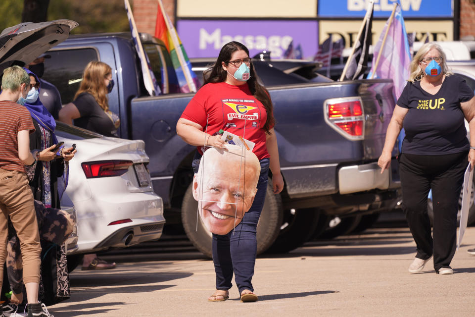 A Supporter of Democratic presidential candidate former Vice President Joe Biden prepares for a Ridin' With Biden event Sunday, Oct. 11, 2020, in Plano, Texas. Democrats in Texas are pressing Joe Biden to make a harder run at Texas with less than three weeks until Election Day. (AP Photo/LM Otero)