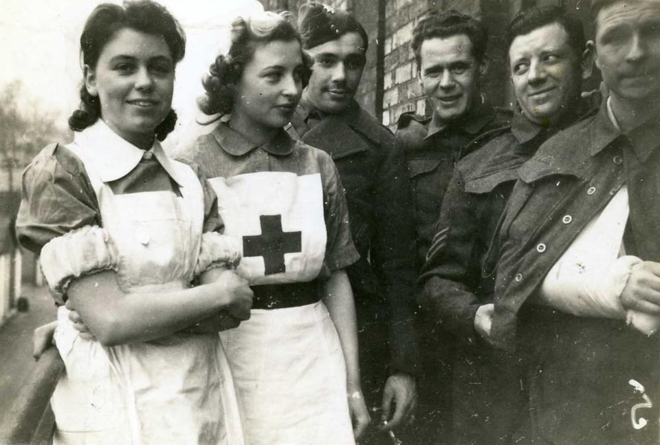 The original black and white version of VAD nurses with the soldiers at Cowley Hospital (British Red Cross/PA)