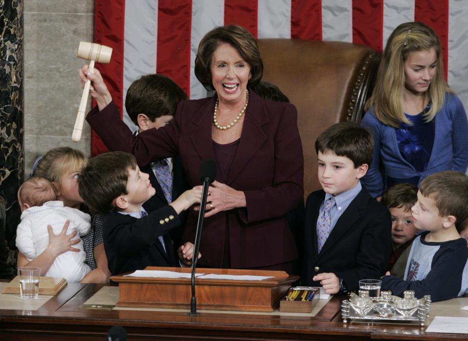 FILE - Newly elected Speaker of the House Nancy Pelosi, holds up the gavel surrounded by children and grandchildren of members of Congress in the U.S. Capitol in Washington, Jan. 4, 2007. (AP Photo/Pablo Martinez Monsivais, File)