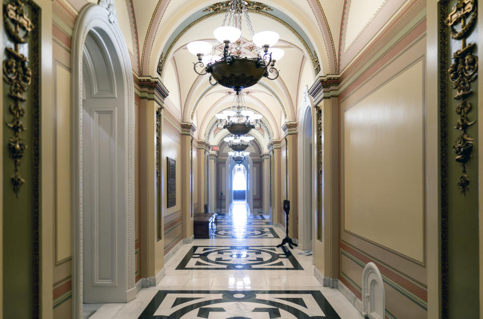 The ornate corridor outside the House of Representatives chamber is devoid of activity, at the Capitol in Washington, Thursday, Oct. 5, 2023, following the ouster of Speaker of the House Kevin McCarthy by a contingent of hard-right conservatives this week. (AP Photo/J. Scott Applewhite)