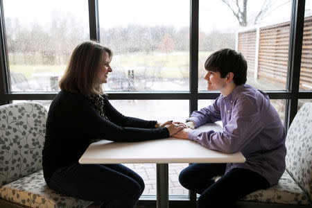 Danny Reagan, a former residential patient of the Lindner Center of Hope, which admits only children who suffer from compulsion or obsession with their use of technology, sits in a common room with his mother Laurie Reagan at the center in Mason, Ohio, U.S., January 23, 2019. REUTERS/Maddie McGarvey