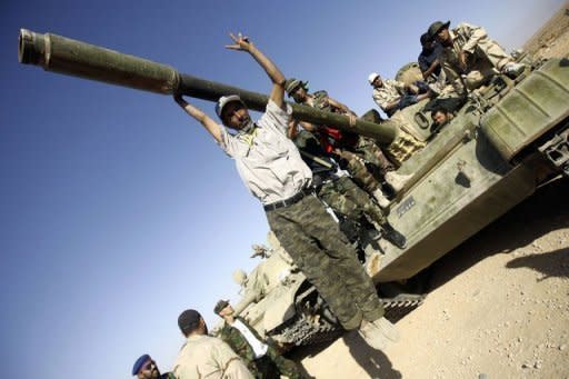 Libyan National Transitional Council (NTC) fighters sit on top of a tank at an outpost on the outskirts of the city of Bani Walid. Libya's new rulers have declared victory in the battle for the key southern city of Sabha, one of the last strongholds of forces loyal to deposed leader Moamer Kadhafi