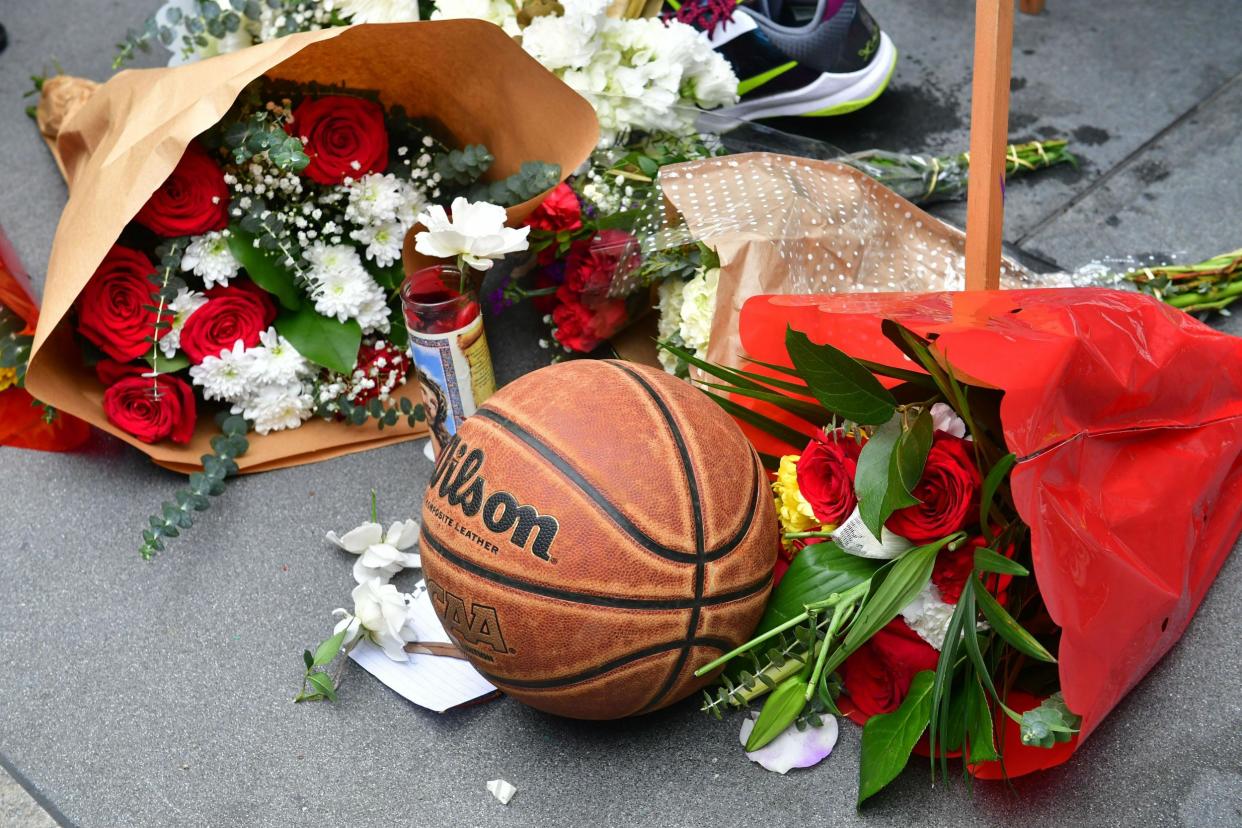 People gathered at a makeshift memorial in Los Angeles after news of the player's death broke: Getty