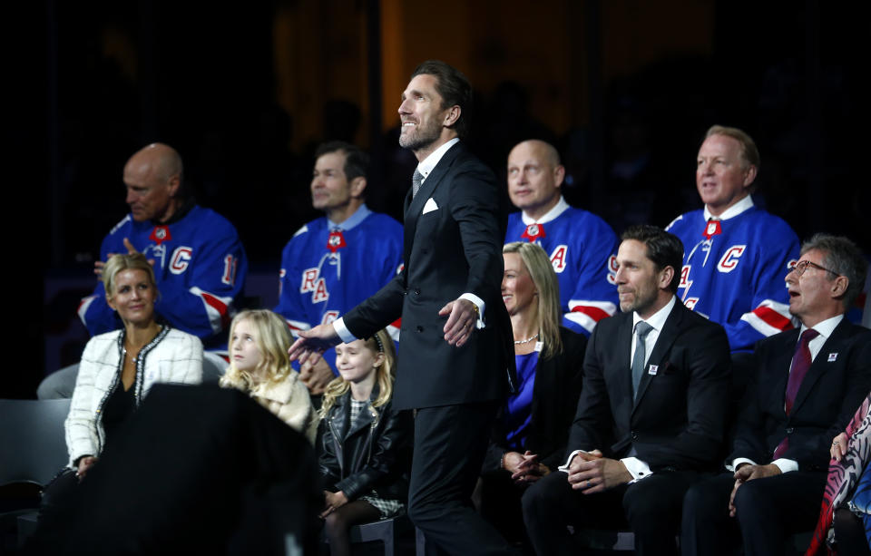 Former New York Rangers goaltender Henrik Lundqvist, center, watches as his number is retired before an NHL hockey game between the Rangers and the Minnesota Wild Friday, Jan. 28, 2022 in New York. . He was joined by four former Rangers who have also had their number retired, left to right, Mark Messier, Mike Richter, Adam Graves and Brian Leetch. (AP Photo/John Munson)